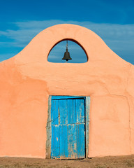 Fototapeta premium Bell over blue door in Sante Fe, New Mexico
