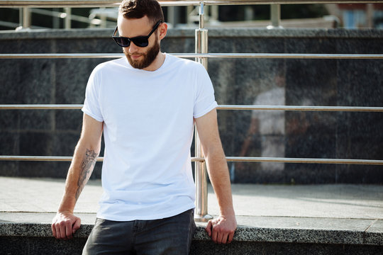 Hipster wearing white blank t-shirt with space for your logo