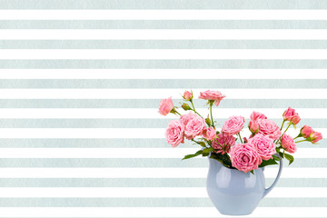 Pink flowers in blue jug on watercolor blue stripes background.