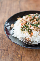 Thai food, rice topped with stir-fried pork and basil.