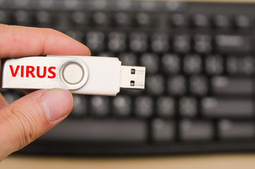 Hand hold blank USB virus thumb drive or virus USB stick with ke