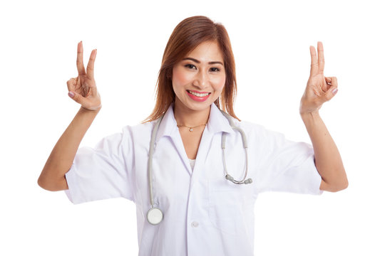 Young Asian female doctor show victory sign with both hands