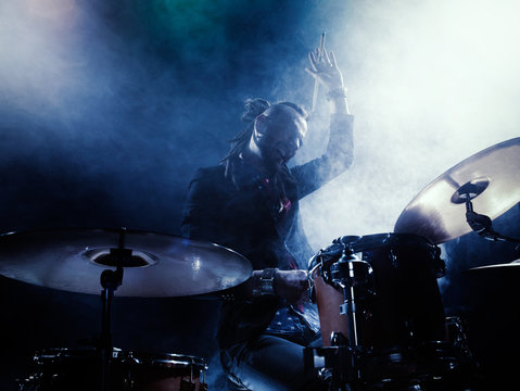 Silhouette of the drummer on stage.