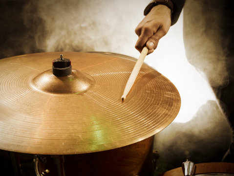 Drummer hitting sticks in ride.
