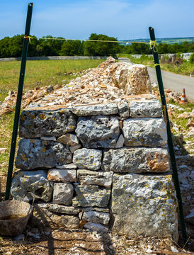 Restore drywall with stones wall in focus in the countryside of Apulia