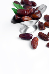 Dates in a bowl on a white background.