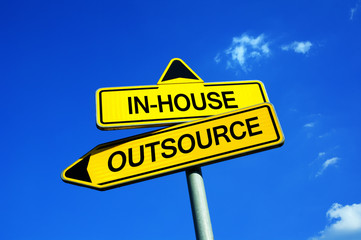 In-house or Outsource - Traffic sign with two options - possibility to contract outside worker and companies for specific job tasks. Business strategy.