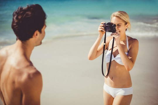 Woman taking picture of her man