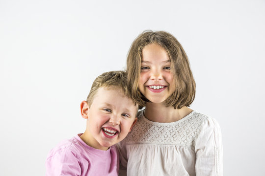 Boy and girl holding each other, sibling love portrait. 