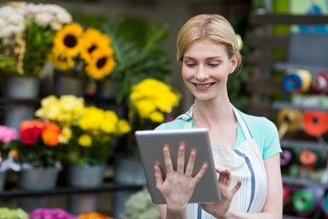 Female florist using digital tablet in florist shop