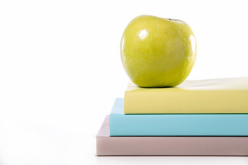 book and green apple