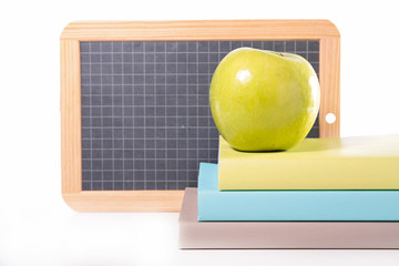 book and green apple
