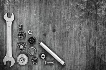 Wrench and machine parts on a gray background.
