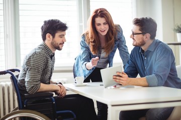 Business people using digital tablet in meeting room