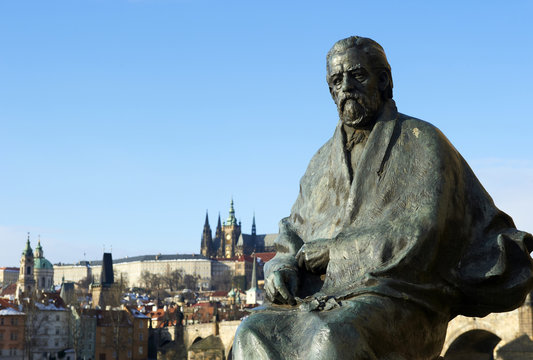  statue of composer Bedrich Smetana with Prague Castle and Charles Bridge background.