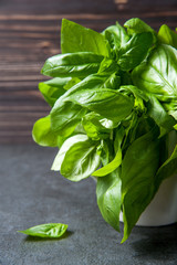 Fresh organic basil leaves on a wooden table