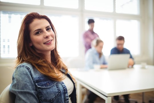 Businesswoman with coworkers in meeting room 