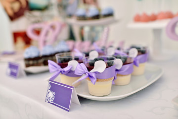 Beautiful wedding restaurant for marriage. White decor for bride and groom. Colorful decoration for celebration. Beauty bridal interior. Bouquet, food and flowers in hall