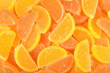 Orange and lemon candy slices as background