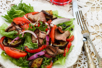 Warm salad of roast beef and vegetables - roasted bell peppers, eggplant, fresh tomatoes, red onion and lettuce with balsamic dressing
