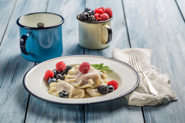 Dumplings with berry fruits and cream