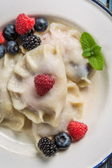 Closeup of sweet dumplings with berry fruits