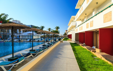 Fototapeta na wymiar Luxury swimming pools in a modern hotel sunny day Greece Rhodos