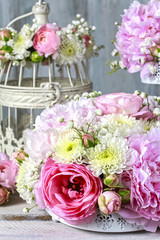 Floral arrangement with pink peonies, tiny roses, chrysanthemums