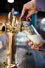 Fototapeta na wymiar Bar tender pouring beer