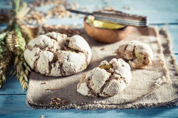 Closeup of tasty rolls with ears of wheat