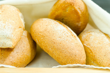Selection of delicous bread buns lying in basket, as seen from above