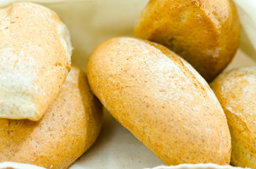 Selection of delicous bread buns lying in basket, as seen from above
