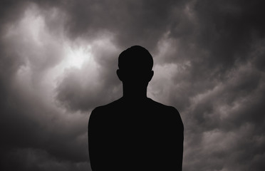 Young man  standing around the dramatic sky before storm