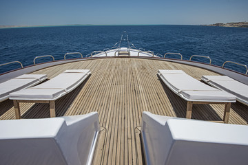 View over the bow over a large luxury motor yacht
