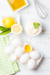 Fresh homemade Mayonnaise and ingredients on white background