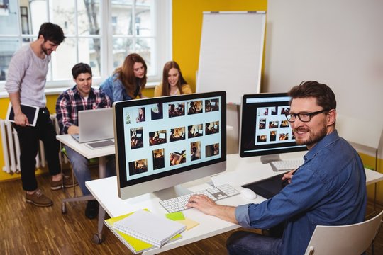 Portrait of male photo editor working on computer
