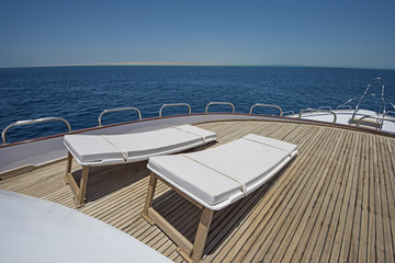 View over the bow over a large luxury motor yacht