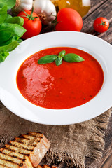 Smooth and sweet tomato soup, seasoned with basil, garlic.