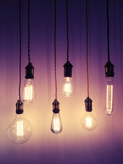 Industrial style light bulbs on purple background