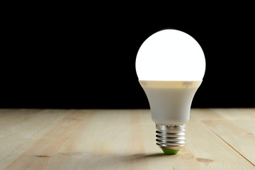 LED lamp standing on a wooden table