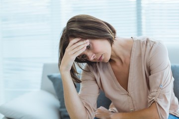 Sad woman sitting on sofa