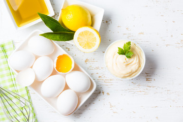 Fresh homemade Mayonnaise and ingredients on white background