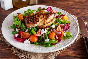 Grilled Chicken Breast fillet with fresh tomatoes vegetables salad. concept healthy food.