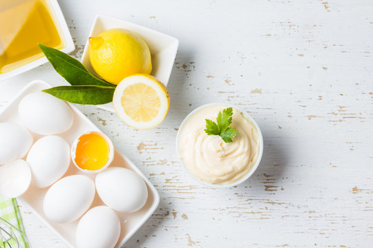 Fresh homemade Mayonnaise and ingredients on white background