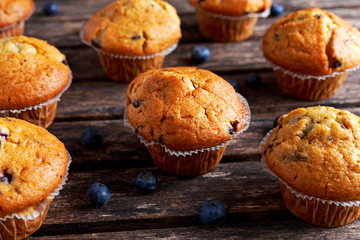 Homemade Blueberry Muffins with fresh berries on wooden table. selected focus