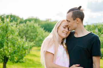 Couple standing in park and hugging