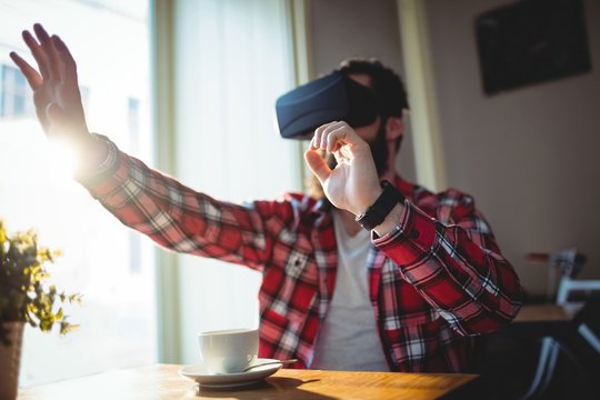 Customer using virtual reality headset at cafe