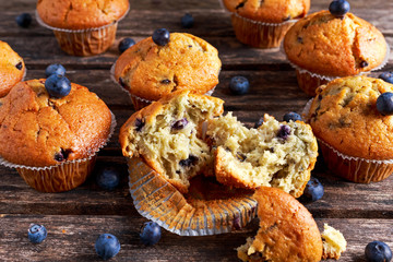 Homemade Blueberry Muffins with fresh berries on wooden table. selected focus
