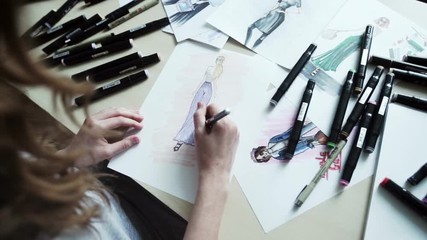 Female fashion designer drawing sketches for clothes - Powered by Adobe
