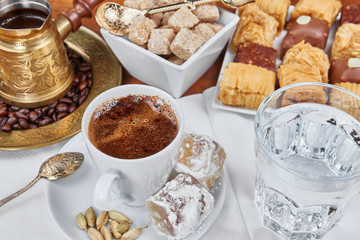 Traditional Turkish black coffee and sweet dainties